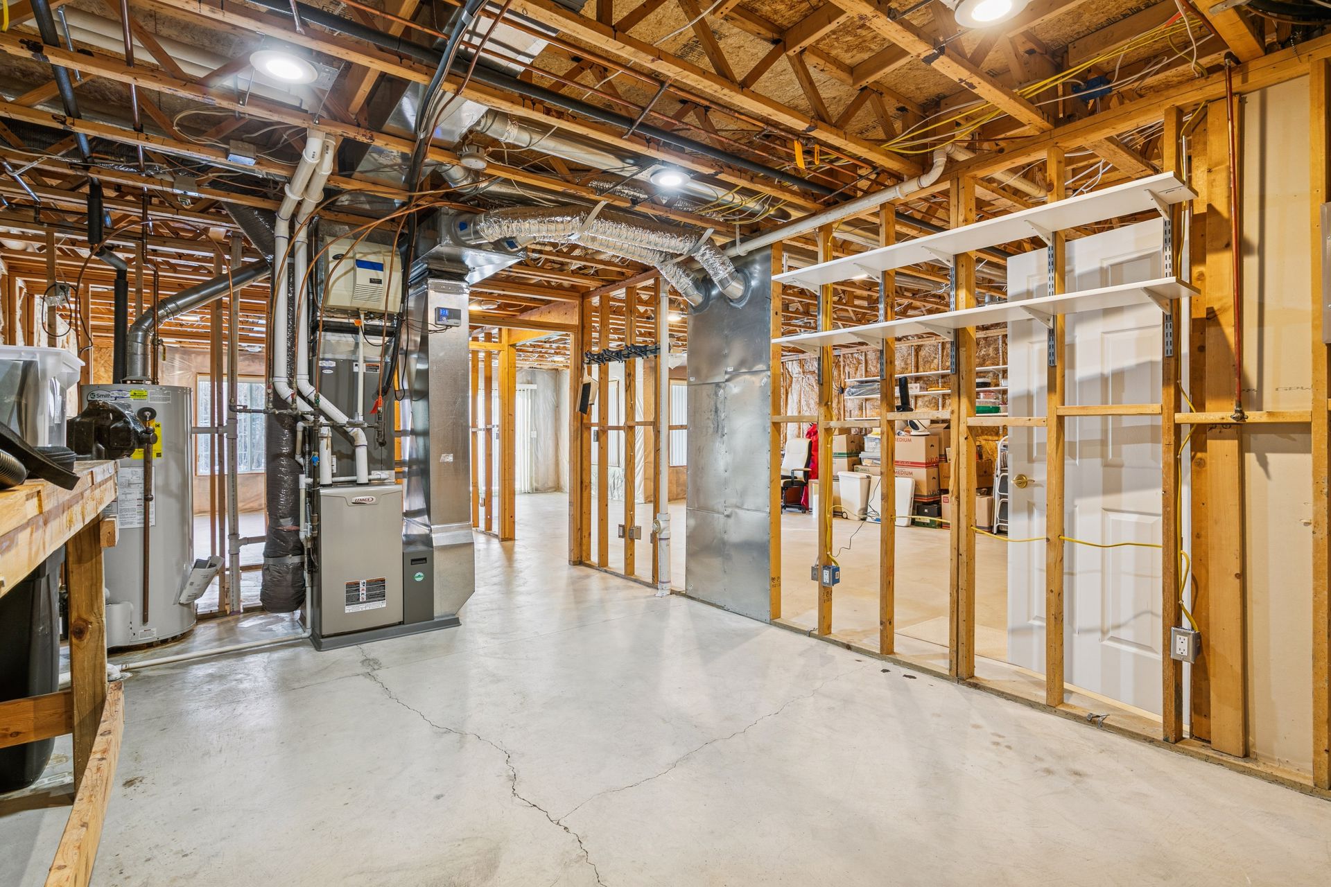 Unfinished lower level provides additional space ready for a second bedroom, and bathroom